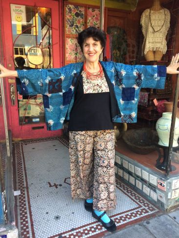 Sleeveless black top with Indian print, $59, matching printed pants, $71, blue-patterned jacket, $91.50 by MARKETPLACE. Red beaded Indian necklace, $16.50