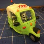 Day of the Dead figurines in taxi