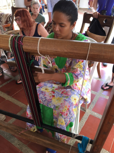 A Wayuu woman weaving a strap for a mochila bag